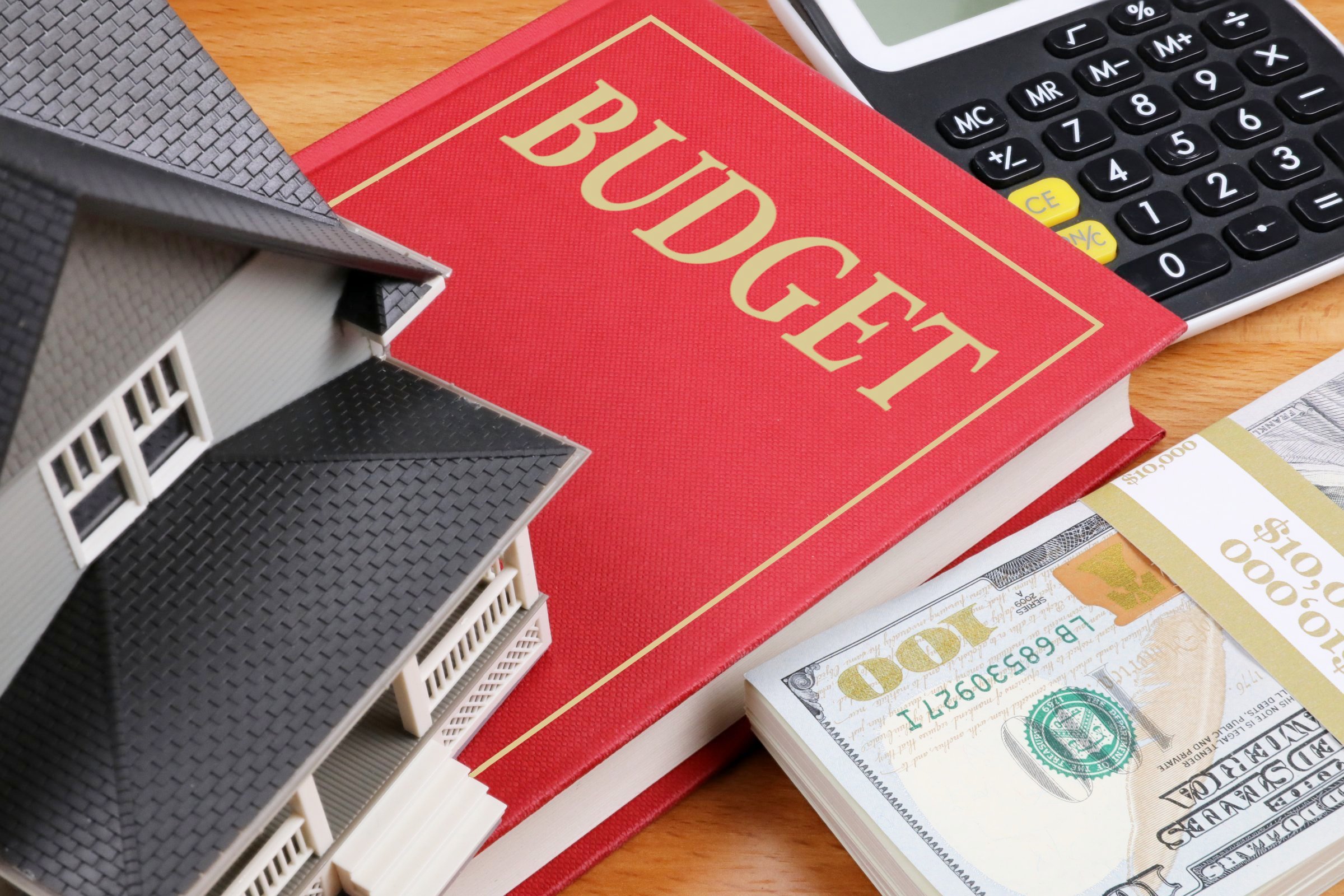 budget-book-with-calculator-and-money-on-desk
