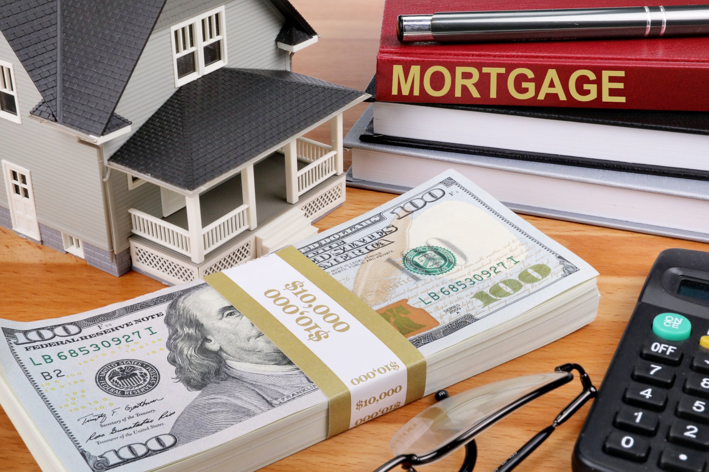 toy-house-on-desk-beside-money